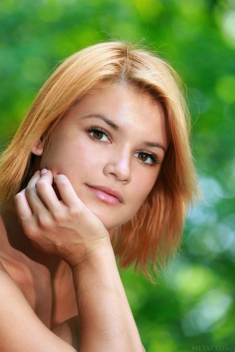 Ukrainian redhead Violla A highlights her big tits and bald pussy outdoors