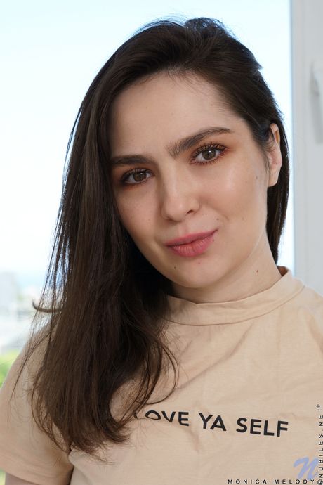 Monica Melody strips down to her black socks and hat before fingering her