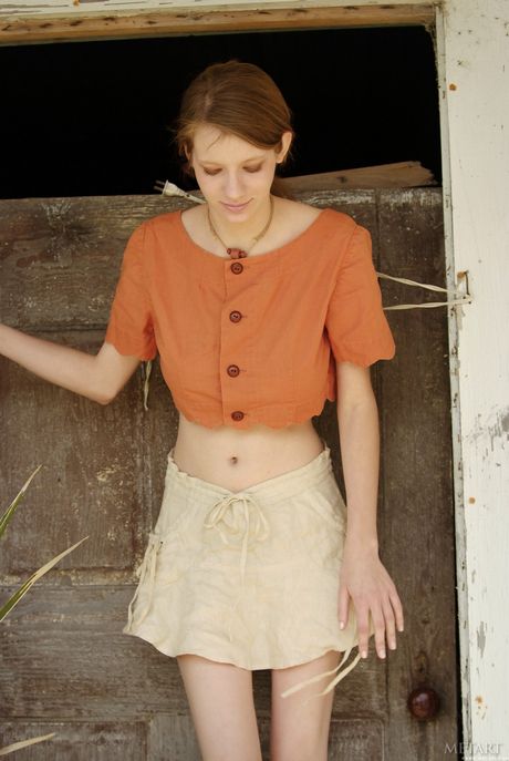 Slender teen Valentine A reveals her hairy cunt and small tits in a solo