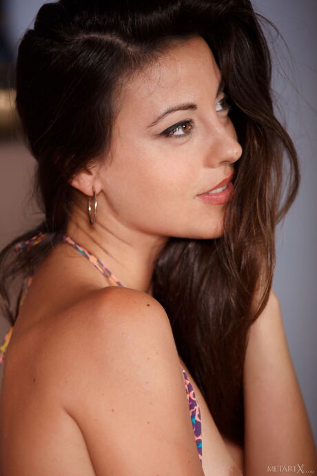 Sexy brunette Lorena B fingers her pussy while listening to music