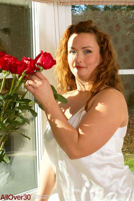 Redheaded MILF Carina F takes off her dress and displays her hairy holes