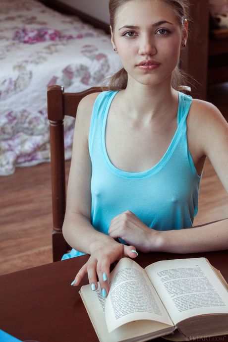 Cute teen Jasmina gets naked on her bed after studying in the nude