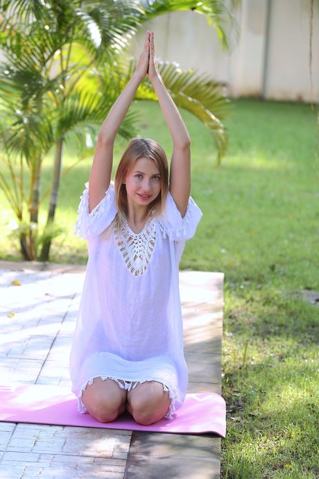 Flexible blonde Dominica gets naked to masturbate in the backyard