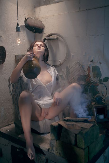 Brunette teen Andrea P masturbates with a bottle of milk in a bathtub