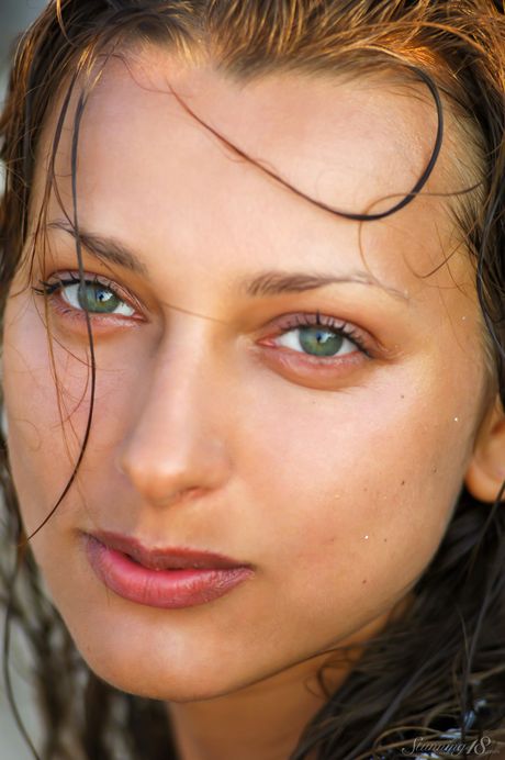 Skinny teen Ambrosine M poses nude on a sandbar in the middle of a lake