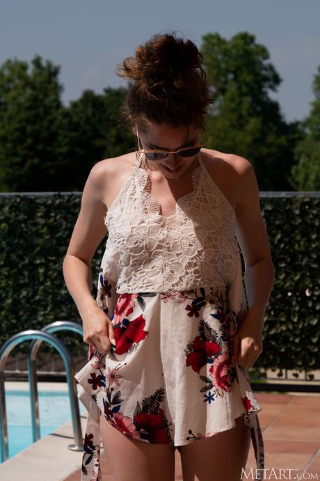 Delicate teen Guinevere Huney gets naked in a pool while wearing glasses