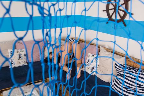 Adorable teen Yasmine A strikes great nude poses on a sofa in her bare feet