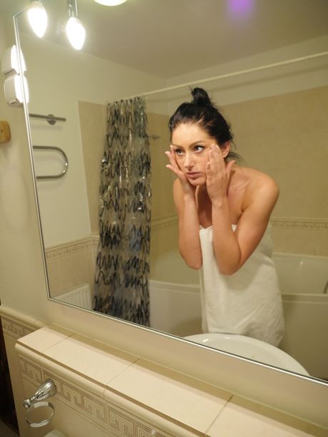 Lean teen Laima R takes a piss after getting naked in the bathroom