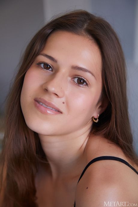 Serina Gomez removes a bodysuit and mesh pantyhose to get naked