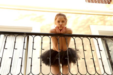 Slender teen Alice May removes her tutu and heels to get naked on a balcony