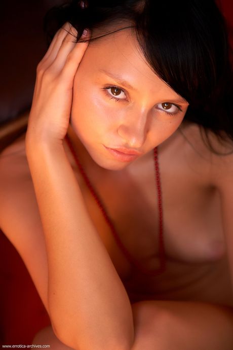 Svelte teen Joli poses nude in her bedroom with her long hair in pigtails