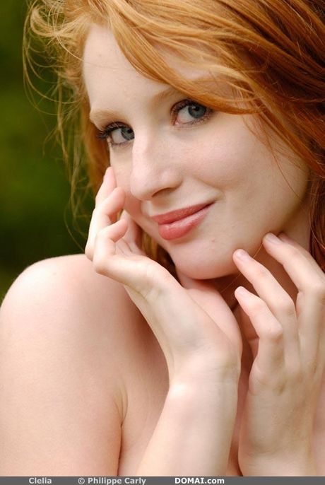 Short redheaded teen Clelia models totally naked without shyness
