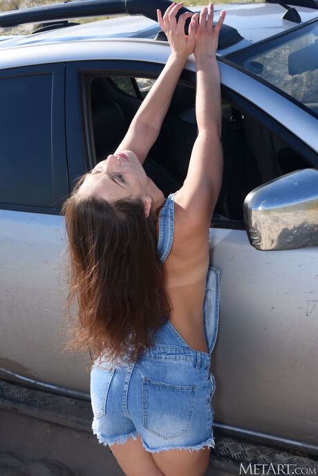 Ukrainian girl Nora Roam gets naked on the beach and poses in the sand