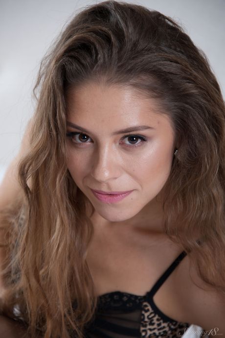 Skinny teen Cassandra removes her lingerie to pose nude in wet socks