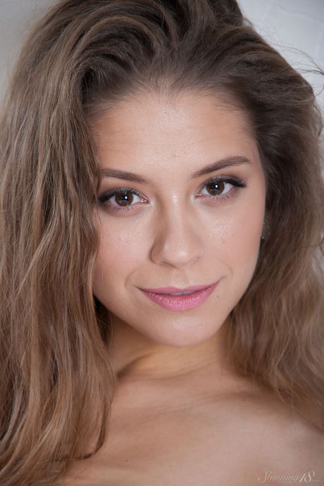 Skinny teen Cassandra removes her lingerie to pose nude in wet socks