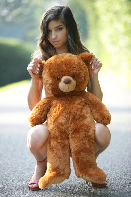 Delightful teen Nika exhibits nudity in a pair of heels on a backyard patio