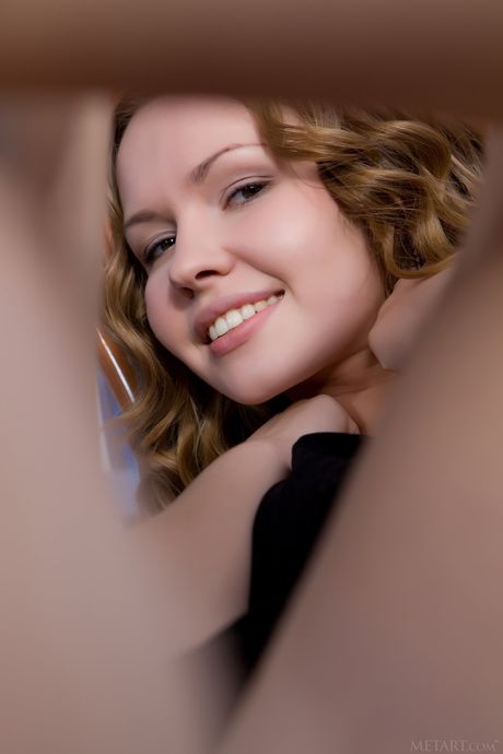 Blonde teen Virginia Sun gets naked enticingly during solo action