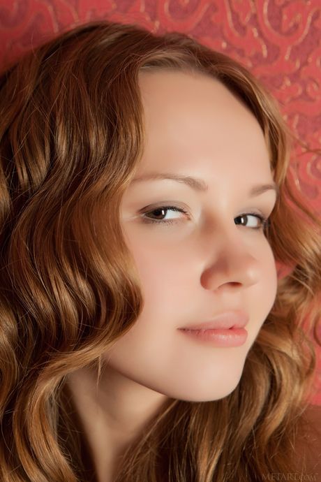 Blonde teen Virginia Sun gets naked enticingly during solo action