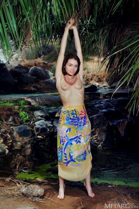 Young beauty Keira Blue goes naked on a riverbank