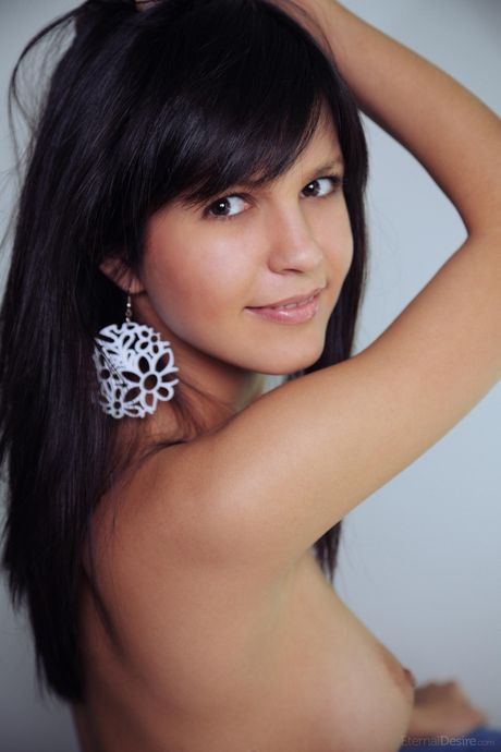 A adolescente esbelta Zelda B mostra seus peitos pequenos e posa nua em um solo
