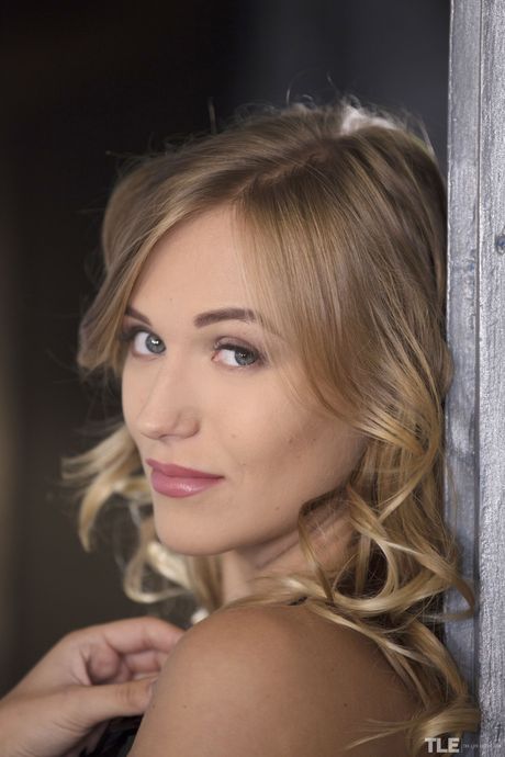 Blonde teen Aislin removes her black dress and heels before fingering her pussy