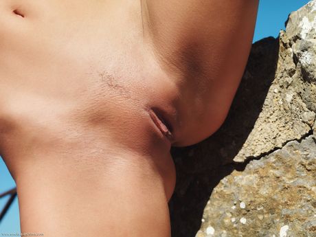 Lesbian girls Paola and Carie get naked on a balcony in the sun