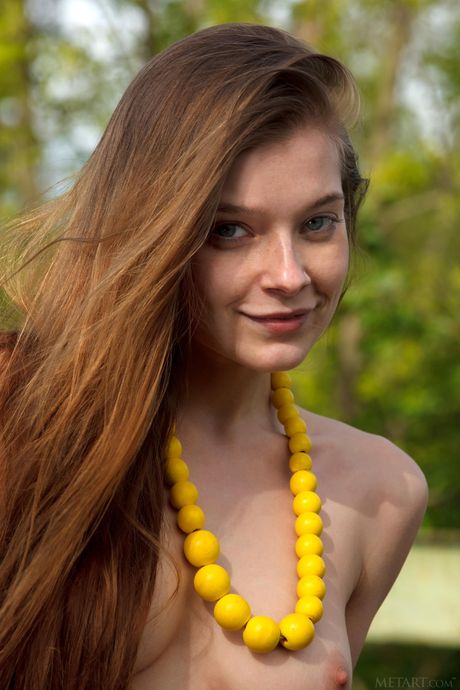 Russian babe Indiana A bares all & presents her small tits & hot body outdoors