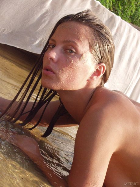 Solo girl Models No Name gets nude in a shallow pool of water