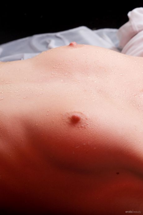 Petite teen Uma A removes her stockings to get naked in a shower