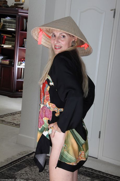 Mature woman Sienna strips off her uniform to show her bushy vagina