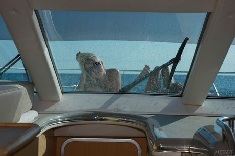 Alluring teen babes Liza B & Evilina A posing nude on a boat in the harbor