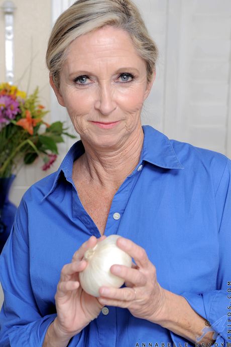 Blonde granny Annabelle Brady gets nude in the kitchen and sprays herself