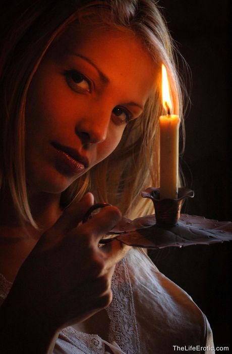 Blonde teen Roxio removes her lingerie before masturbating with a candle