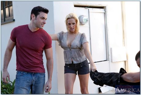 Blonde cougar Jessie Cash seduces a young man while wearing a red dress