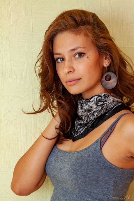 Adorable teen Irina J highlights her landing strip pussy while totally naked