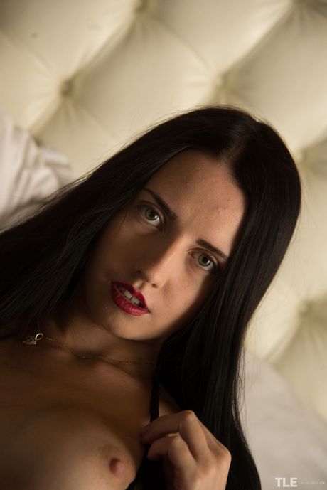 Pretty teen Veronica Snezna removes white lingerie before masturbating in stockings