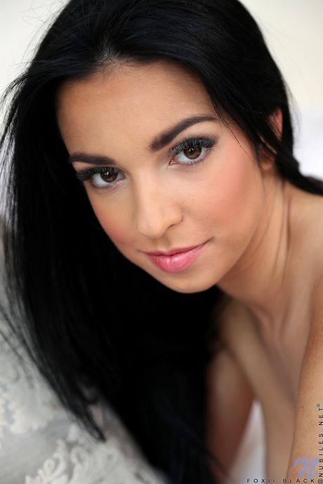 Skinny teen Foxii Black removes her lingerie before toying her pussy