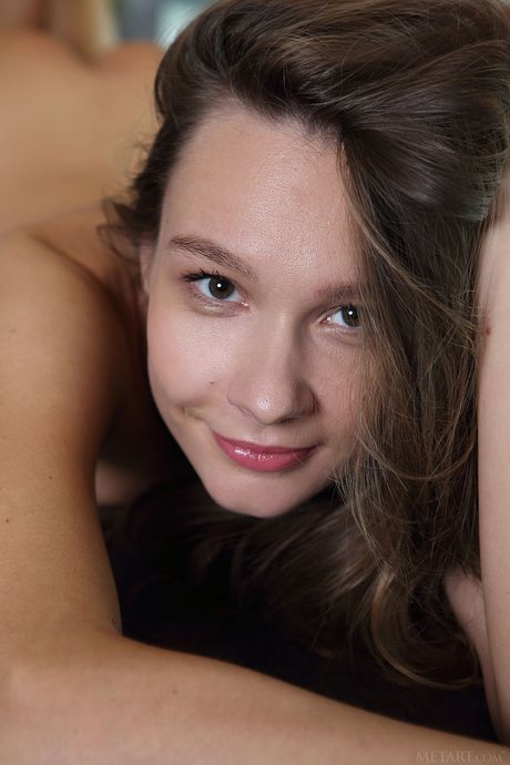 Lean teen Mirabella removes her bikini and panties to pose nude in the kitchen