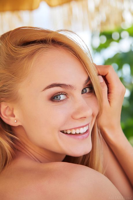 Young blonde Nancy A goes naked on a patio with certainty