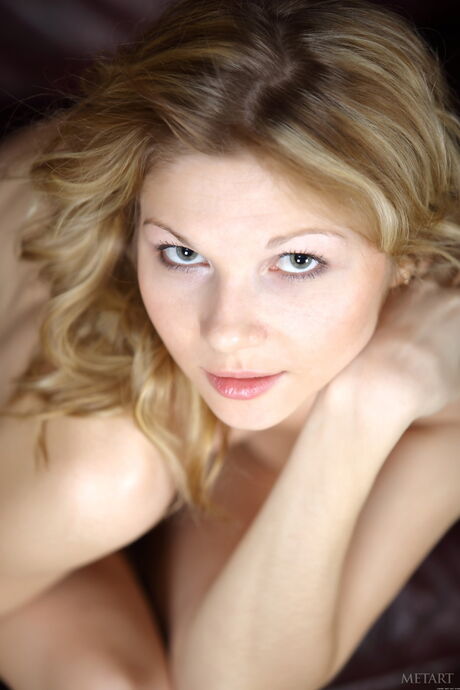 Blonde teen Heike A removes her bra and panties to pose nude