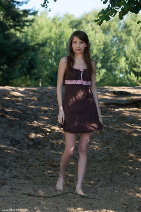 Brunette teen Jemma A gets naked on a rocky outcropping