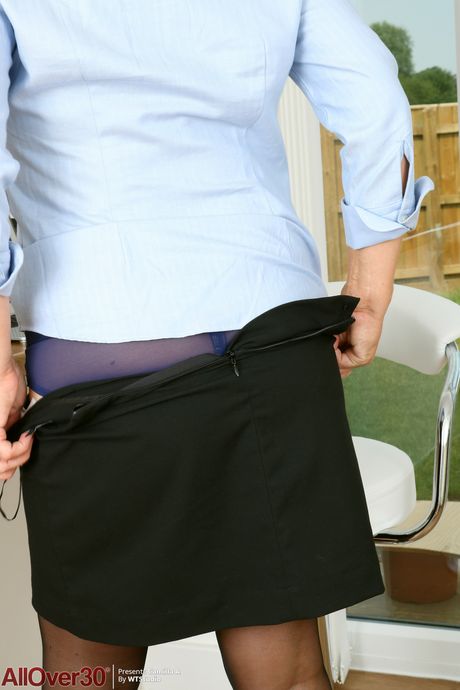 Blonde mature in glasses Camilla A unveils her big tits and poses