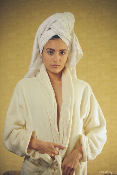 Gorgeous teen Cira Nerri fingers her pussy after removing a bathrobe