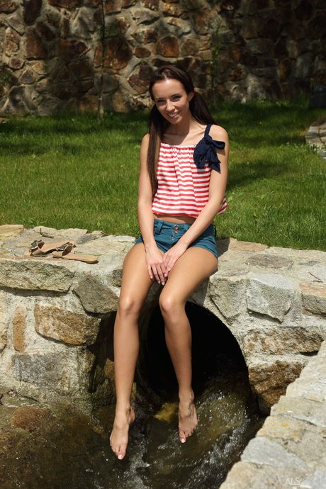 Thin teen Gina Devine toys her pussy with a speculum in the creek