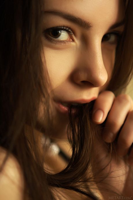 Brunette teen Una Piccola removes her clothes to pose nude in heels