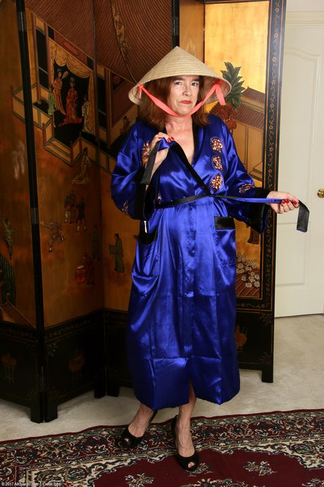 Mature redhead Melody Garner strips off her uniform and shows her holes