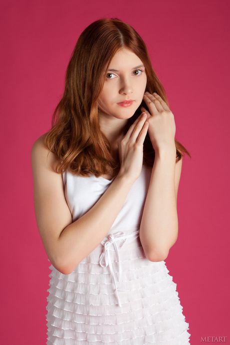 Redheaded teen Orabelle A removes a dress to pose nude fearlessly