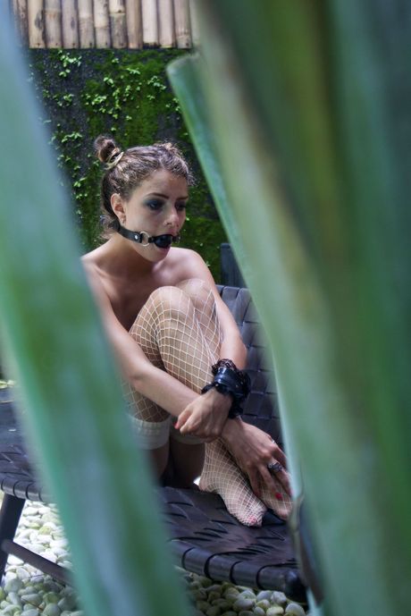 Thin teen Jacinta B removes her pink dress to get naked in fishnets