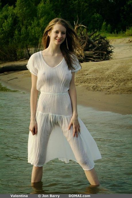 Thin teen Valentina gets naked on a sandy beach and in the water