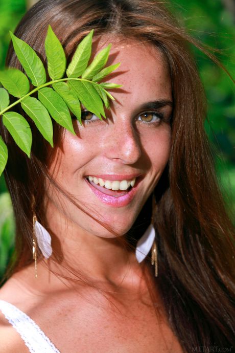 Thin teen Fernanda strips and poses nude in the middle of a forest